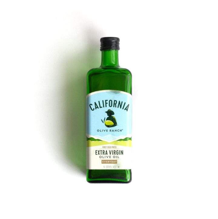 A bottle of California extra virgin olive oil on a white background.