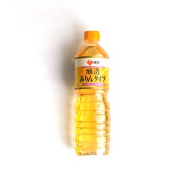 A bottle of Morita mirin over a white background.