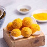 Korean mozzarella cheese balls in a wood serving box lined with parchment.