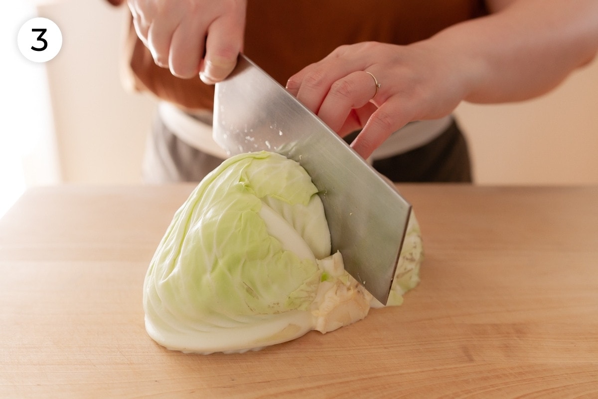 Cindy cutting half of a head of Taiwanese cabbage into quarters with the flat side down on the cutting board, labeled with a circled number "3."