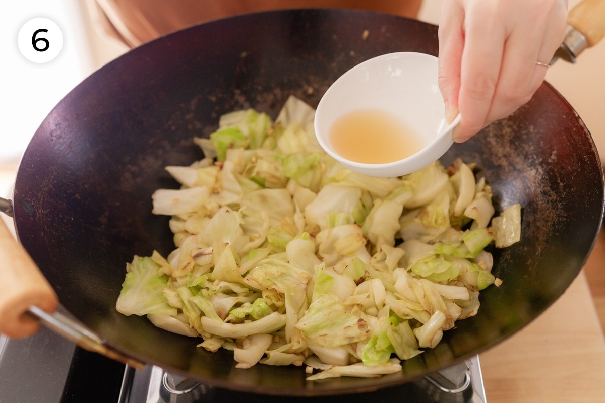 Cindy pouring rice vinegar over the cabbage in the wok, labeled with a circled number "6."