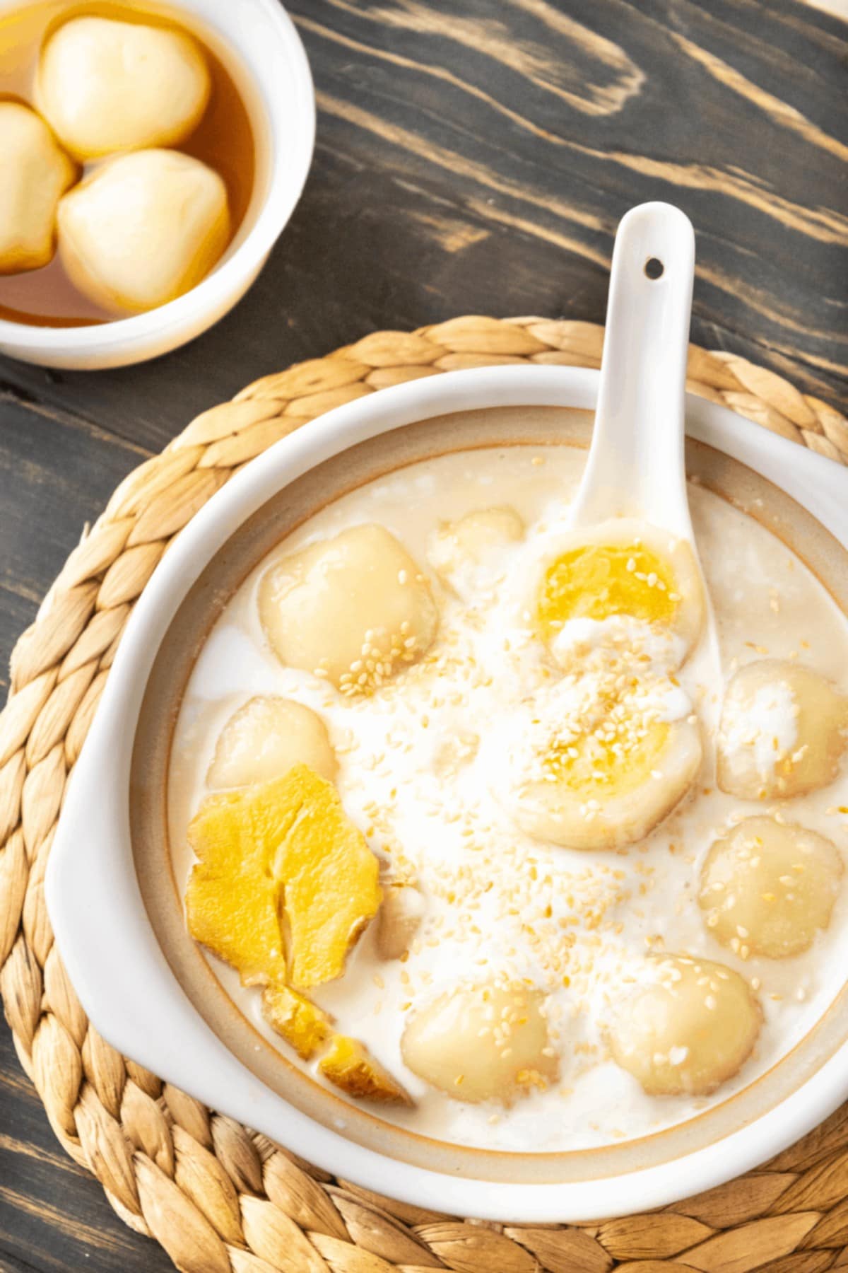 Vietnamese glutinous rice balls in a bowl with a spoon in it.