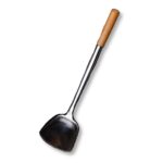 A long metal wok spatula with a wood handle over a white background.