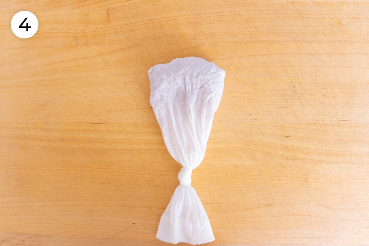 Recipe step 4: The mesh spice bag filled with aiyu seeds and tied shut at the top, leaving 2 inches (50 millimeters) of space between the knot and the seeds.