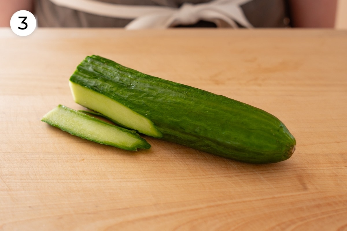 Recipe step 3: Half of an English cucumber with a thin sliver cut off the bottom to create a flat surface.