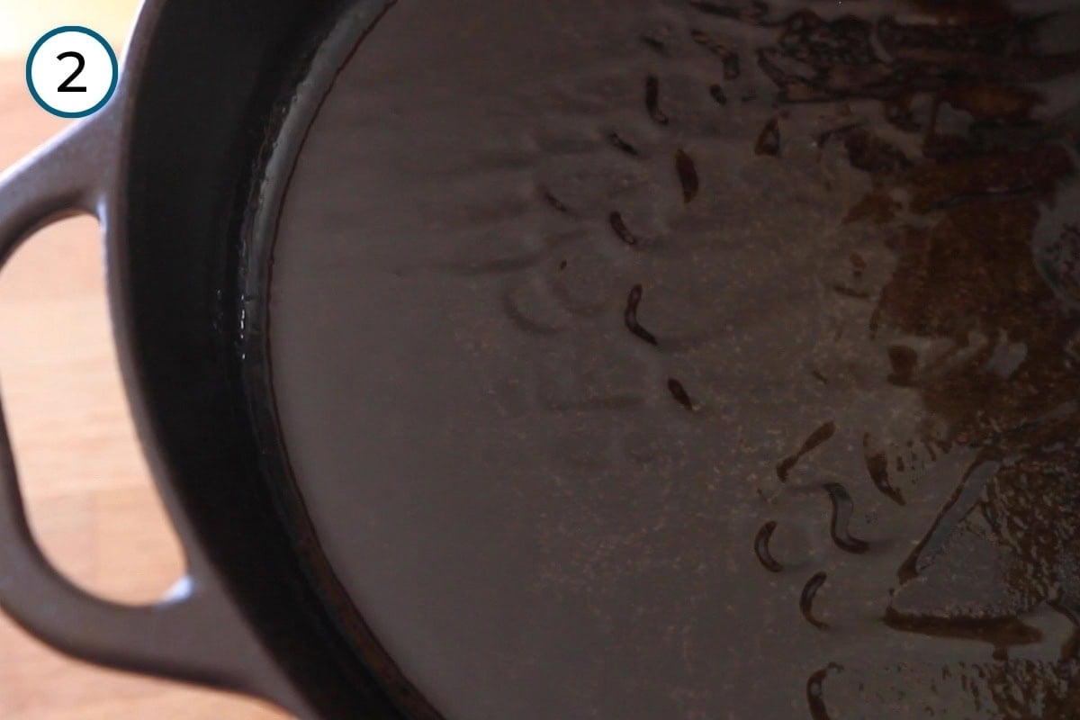 Stir-fried morning glory step 2 - Oil ripples in a cast iron pan to show that it's hot.